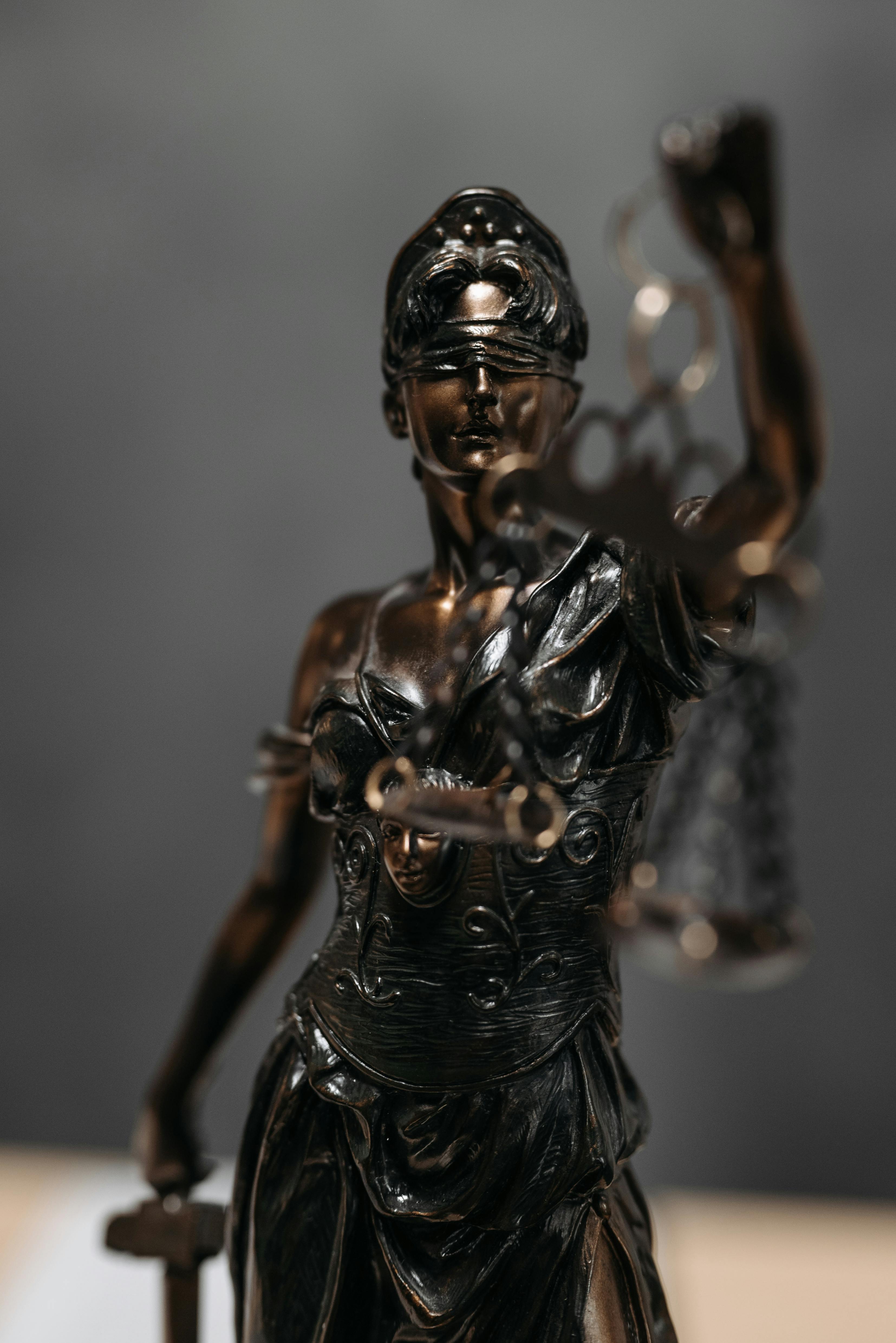 Bronze statue of Lady Justice holding scales and a sword